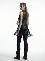 Person wearing a black leather fringe vest on a white background