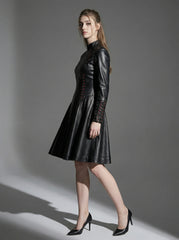Womenβs black leather fit and flare dress shown in side pose with high neck collar and gothic fashion styling