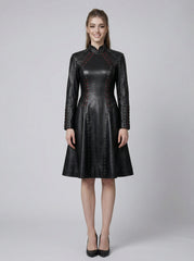 Front view of black leather gothic dress with long sleeves, structured high neck, fitted waist, and knee length skirt