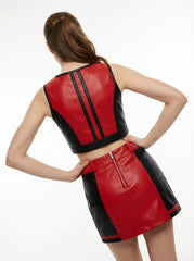 Red and black leather outfit worn by a model on a white background