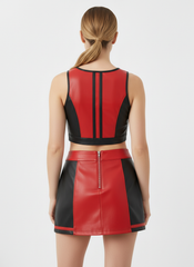 Red and black leather outfit worn by a model on a white background