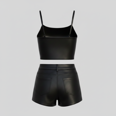 Black faux leather two-piece outfit featuring a strappy cropped camisole and tailored high-rise shorts.