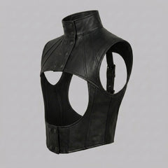 Black leather harness top with high collar, snap button closure, curved front opening, and edgy alternative styling.