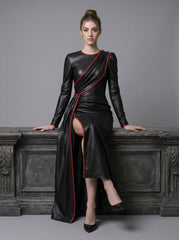 Model wearing black red leather gown with front slit, draped leather overlay, red piping, and elegant formal black dress design - Rizwards Leather