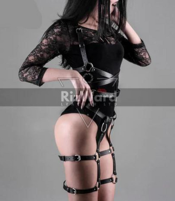 Sexy woman wearing black leather thigh harness with adjustable straps for BDSM play