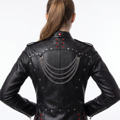 Three-quarter view of women’s black leather motorcycle jacket with silver chain shoulders, studded panels, and cyberpunk fashion look