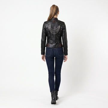 Women’s black leather gothic cyberpunk biker jacket back view with silver chain draping, studded rivets, and red lace-up details