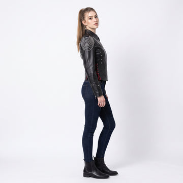 Women’s black leather gothic cyberpunk biker jacket back view with silver chain draping, studded rivets, and red lace-up details