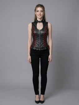 Black gothic leather vest for women with high neck collar, red lace-up side detail, sleeveless fitted corset style, and black pants in stone arch photoshoot
