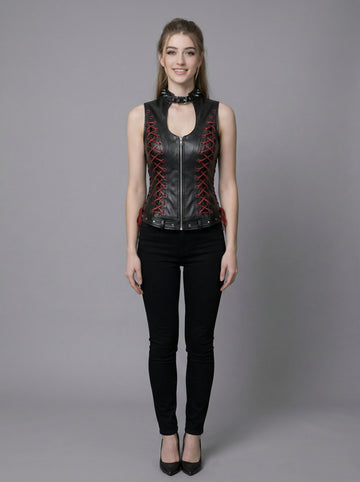 Black gothic leather vest for women with high neck collar, red lace-up side detail, sleeveless fitted corset style, and black pants in stone arch photoshoot