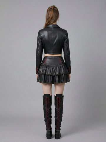 woman wearing black gothic leather skirt set with cropped top jacket and studded mini skirt