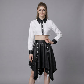 woman wearing black and white leather two-piece skirt set with crop top and handkerchief-hem skirt.