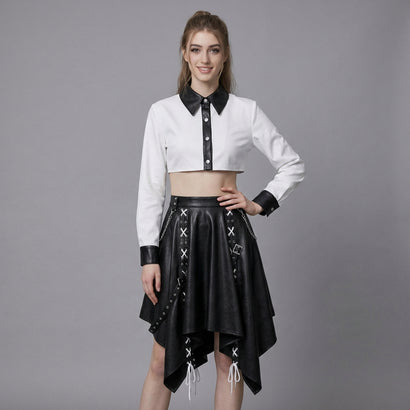 woman wearing black and white leather two-piece skirt set with crop top and handkerchief-hem skirt.