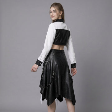 woman wearing black and white leather two-piece skirt set with crop top and handkerchief-hem skirt.