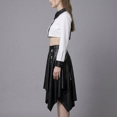 Person wearing a white crop top and black leather skirt on a gray background