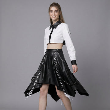 woman wearing black and white leather two-piece skirt set with crop top and handkerchief-hem skirt.