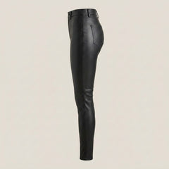Women’s slim leather trousers in black with a polished surface, fitted legs, and modern fashion styling.