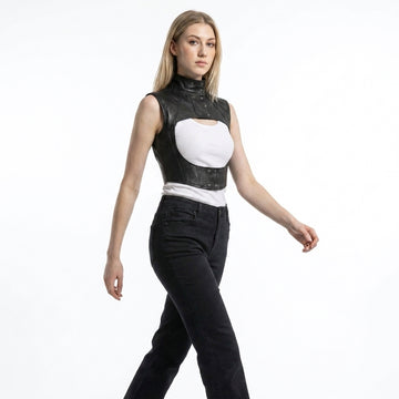 Women’s black leather cropped harness vest with high snap collar, open chest cutout, and structured gothic design.