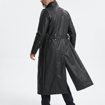 Man wearing a black leather gothic coat with silver buckles on a white background