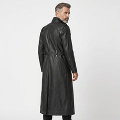 Dark alternative fashion trench coat in black leather with military-inspired buckles, high neck, and long dramatic hem.
