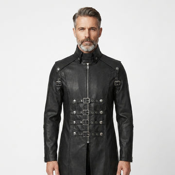 Man wearing a black leather gothic coat with silver buckles on a white background