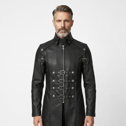 Man wearing a black leather gothic coat with silver buckles on a white background