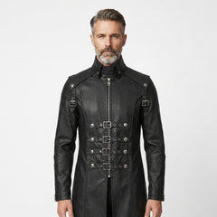 Man wearing a black leather gothic coat with silver buckles on a white background