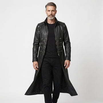 Man wearing a black leather gothic coat with silver buckles on a white background