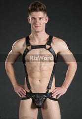 Model wearing a bdsm chest harness outfit with detailed leather straps and black buckles.
