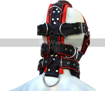 Man wearing a full body harness BDSM outfit in black and red with sexy jockstrap.