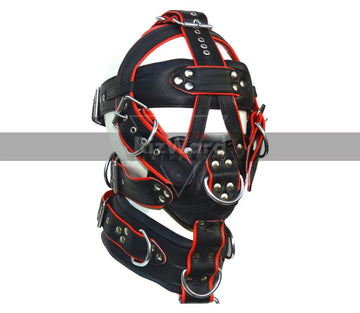 Man wearing a full body harness BDSM outfit in black and red with sexy jockstrap.