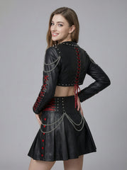 Side view of black gothic leather skirt set for women featuring punk bolero jacket, red lace-up waist, studded details, and chain accents