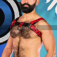 Close up of Bondage chest harness featured in red and black, shown with chained prop for dramatic effect.