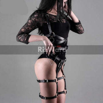 Sexy woman wearing black leather thigh harness with adjustable straps for BDSM play