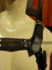 Close-up of full body harness BDSM gear showing thick bdsm chest harness, full-grain leather straps with clean stitching and polished buckles.